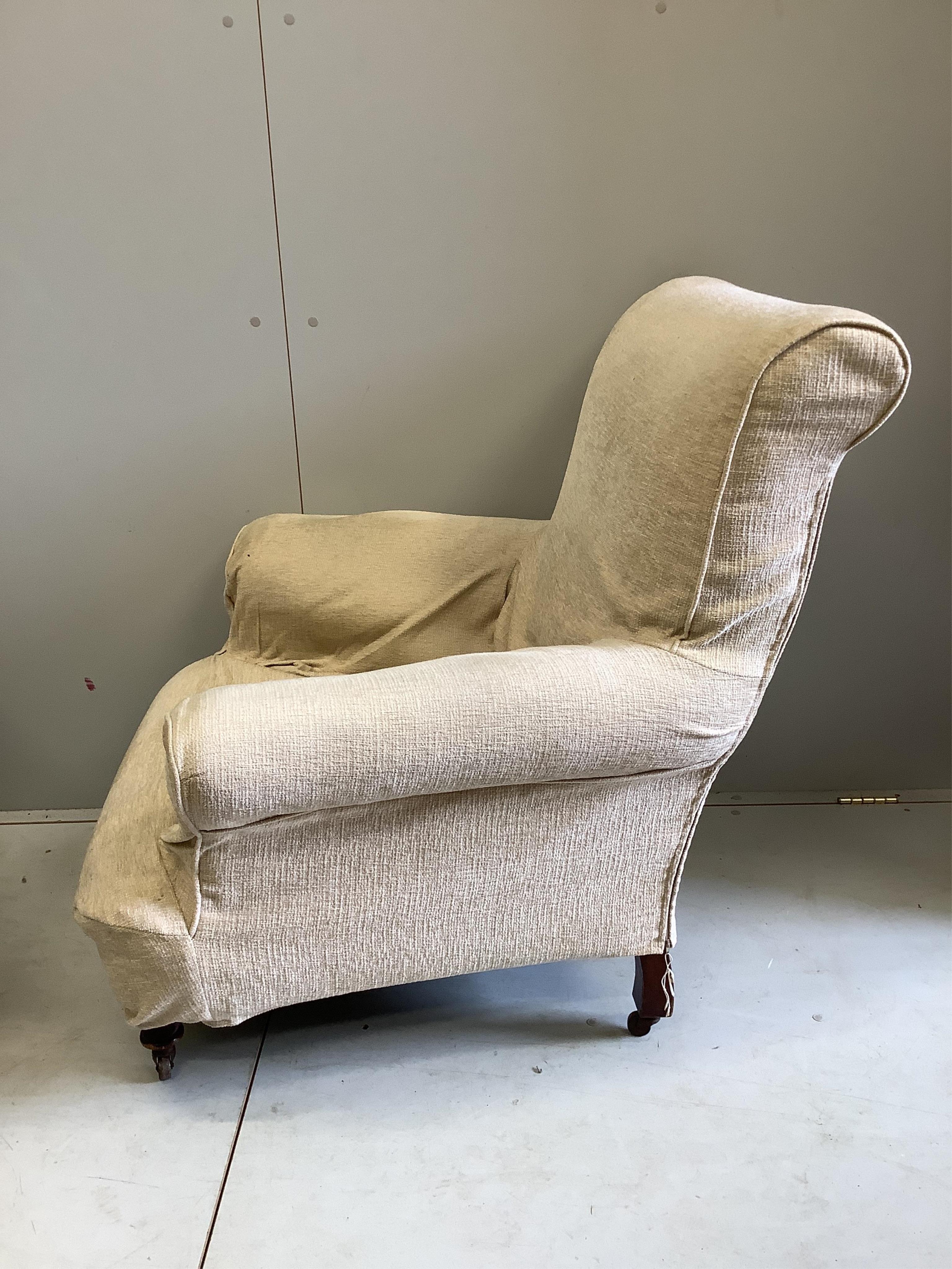 A pair of early 20th century Howard style upholstered armchairs, width 90cm, depth 86cm, height 93cm. Condition - one poor, one fair